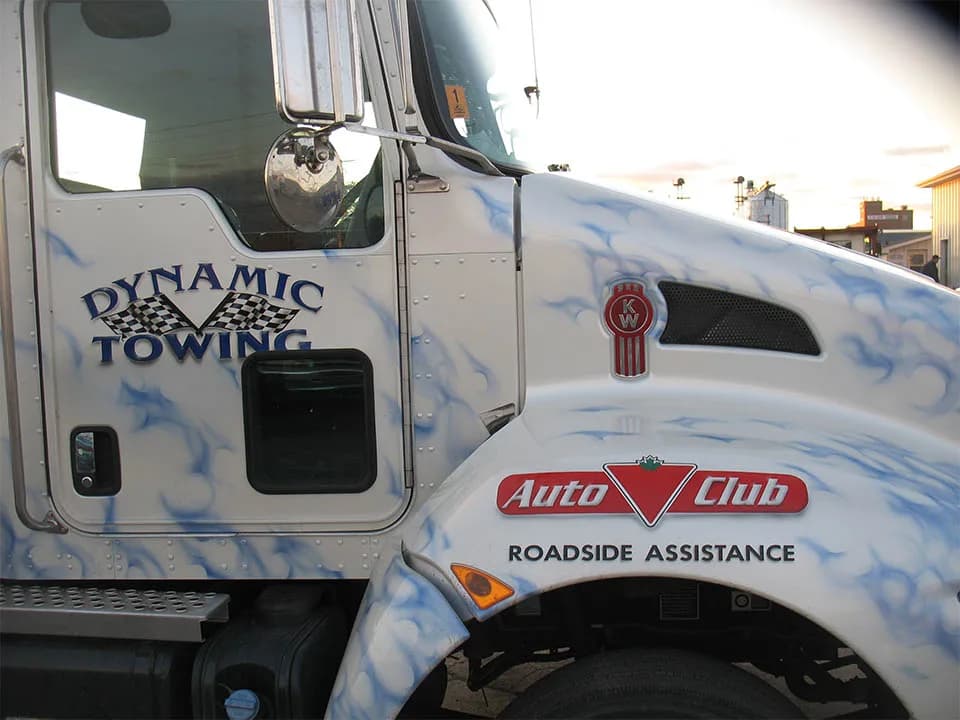 Dynamic Towing Kenworth cab with Auto Club Roadside Assistance branding